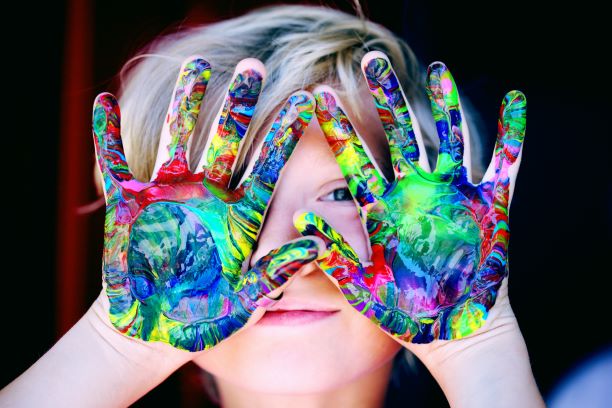 child with paint on hands